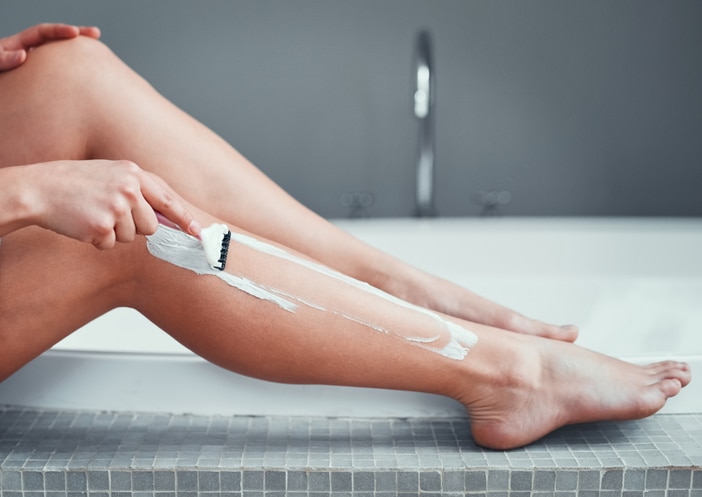 woman shaving leg