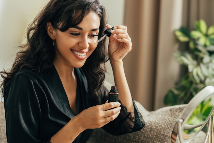 young woman applying skin care routine