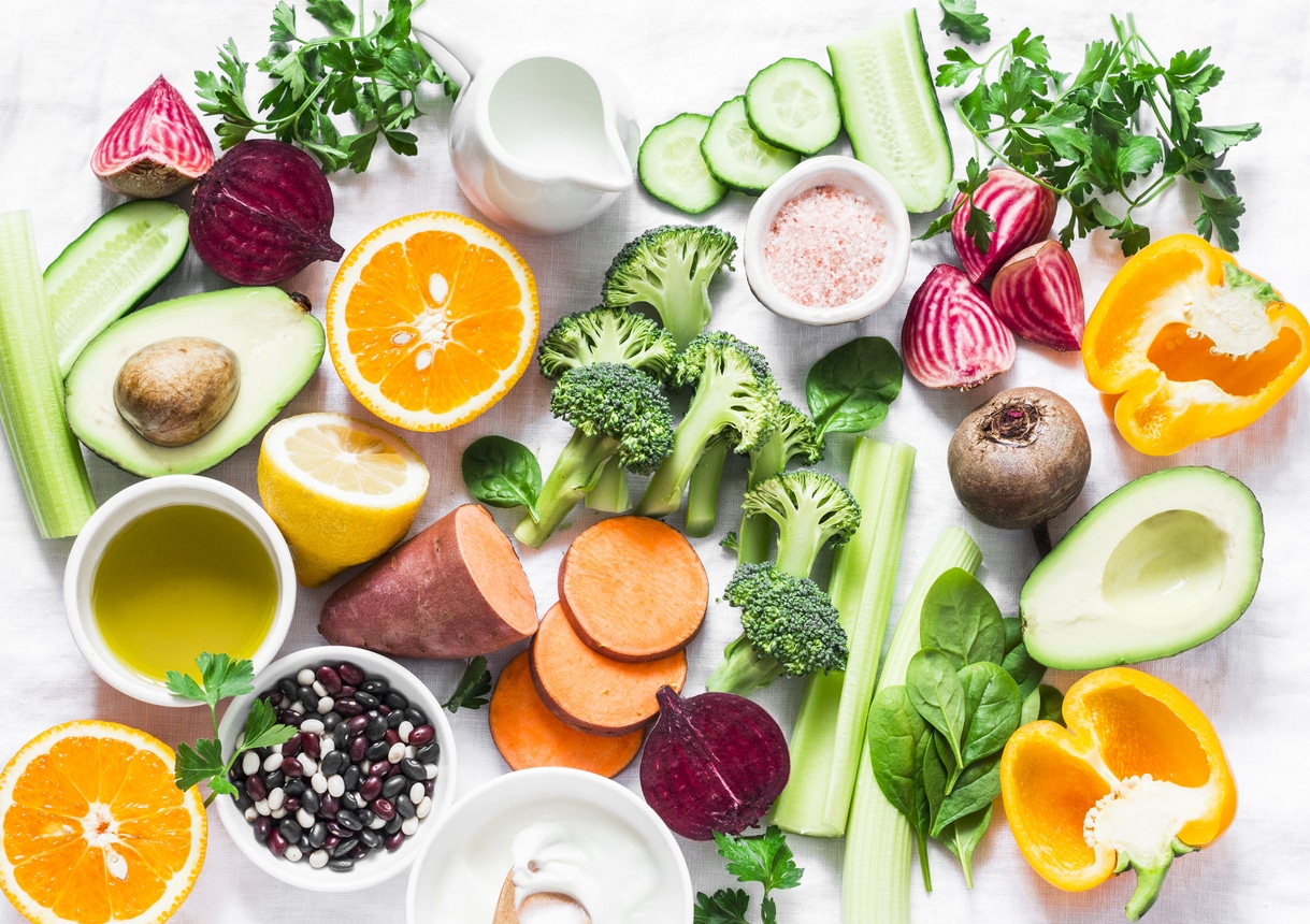 Five best vitamins for beautiful skin. Products with vitamins A, B, C, E, K broccoli, sweet potatoes, orange, avocado, spinach, peppers, olive oil, dairy, beets, cucumber, beens. Flat lay, top view